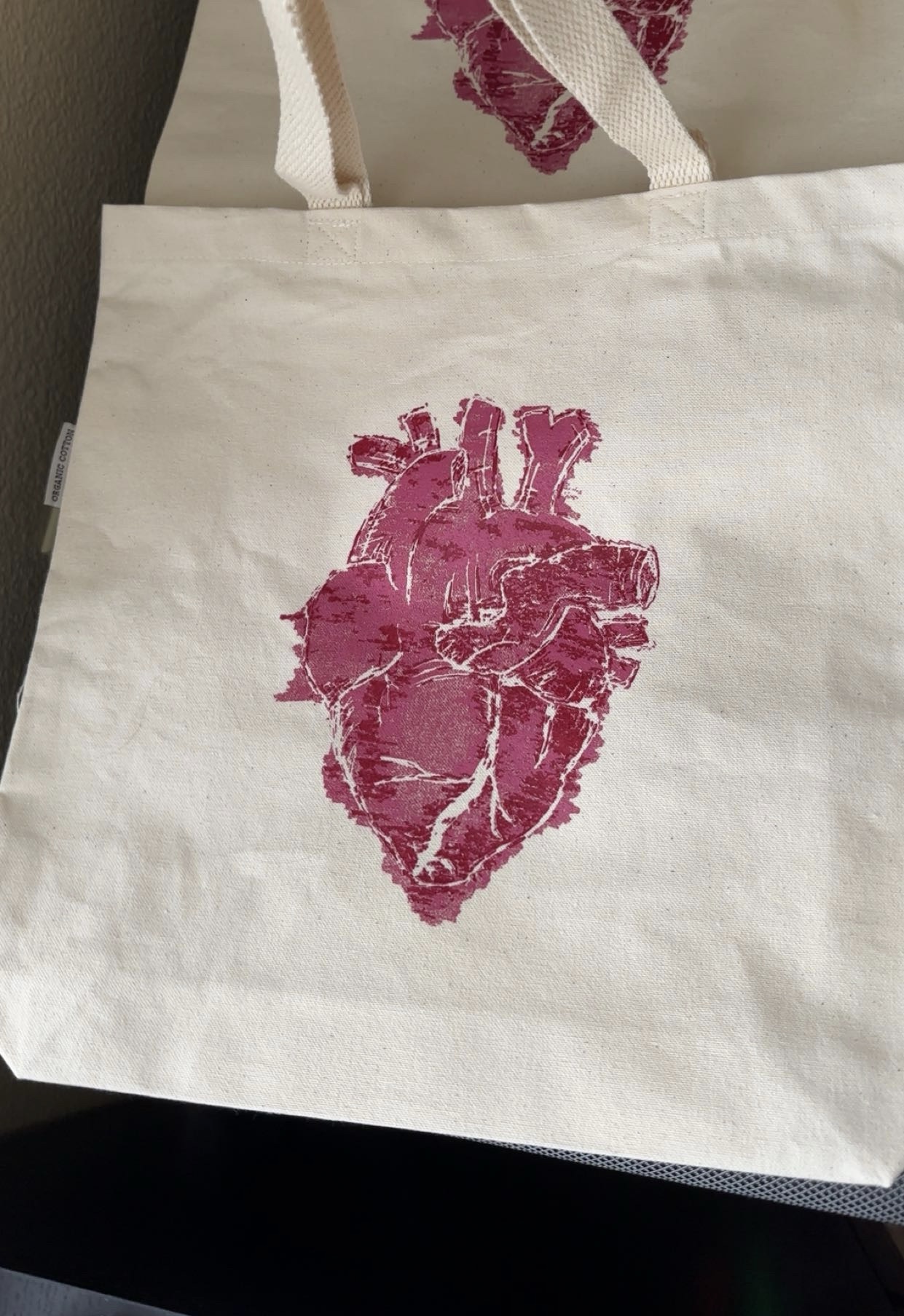 a tote with a screen printed heart on it